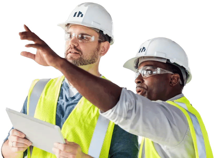 Two construction employees assessing job site